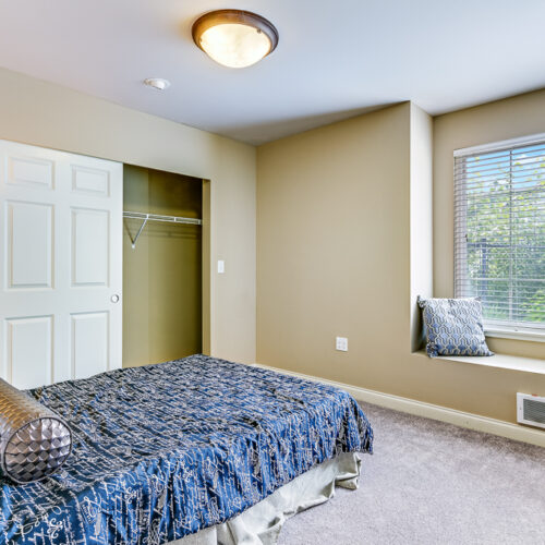 Bedroom in the cottage with bed and entrance to closet