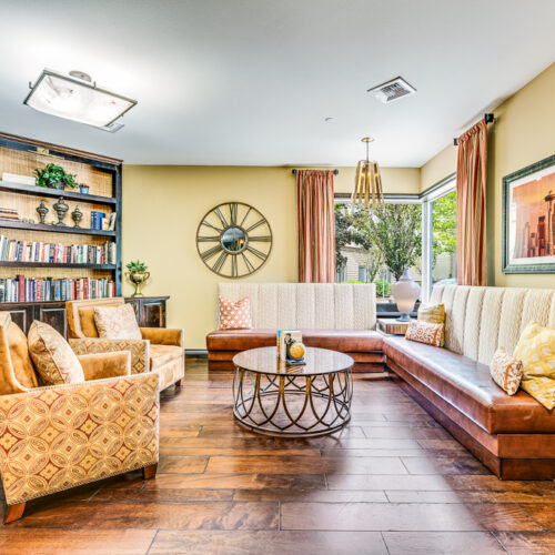 Cozy common area with couches and chairs surrounding a circular table