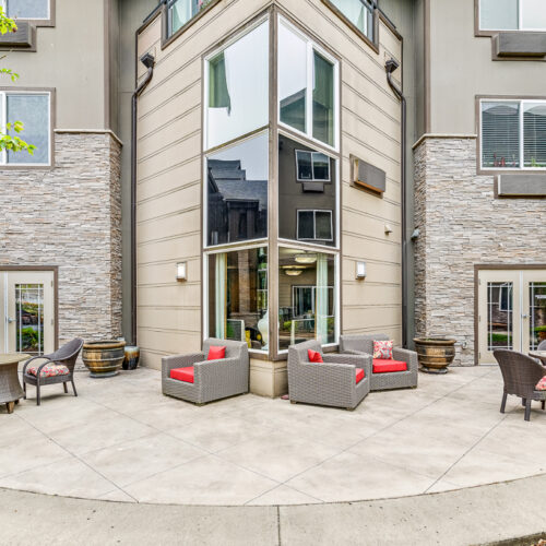 Patio area in front of large windows and community