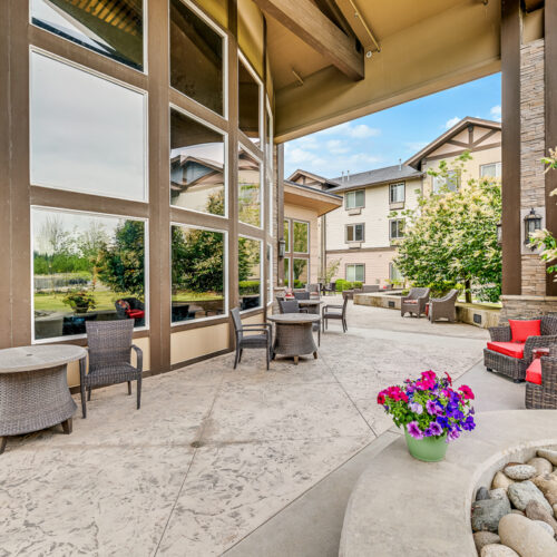 Covered patio area near community with flowers