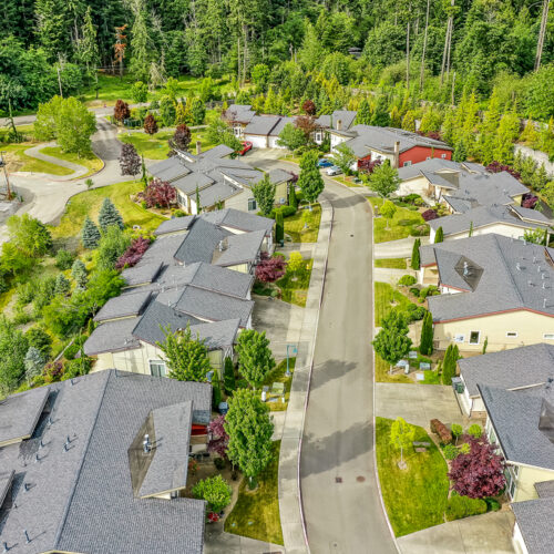 Aerial view of the cottages surrounded by trees and green lawns